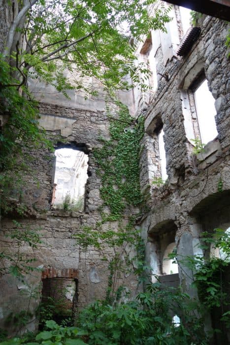 Mostar: Discovering the scars of the war that rocked Bosnia. The bombed out buildings that remain, Bosnia and Herzegovina, Bombed out buildings, sniper towner, exploring the sniper tower, how to get in, is it safe, mountains, cross, view from sniper tower, bullet holes, yugoslavia, balkan war, siege, fighting, croats, serbs, bosnians, muslims, front line, history