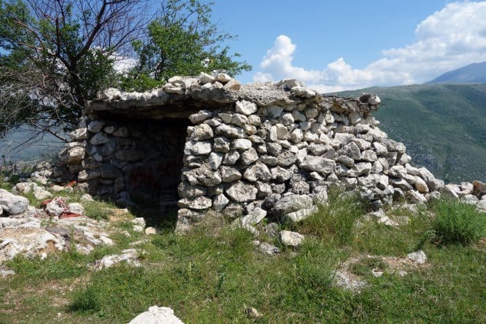 Mostar: Discovering the scars of the war that rocked Bosnia. The bombed out buildings that remain, Bosnia and Herzegovina, Bombed out buildings, sniper towner, exploring the sniper tower, how to get in, is it safe, mountains, cross, view from sniper tower, bullet holes, yugoslavia, balkan war, siege, fighting, croats, serbs, bosnians, muslims, front line, history