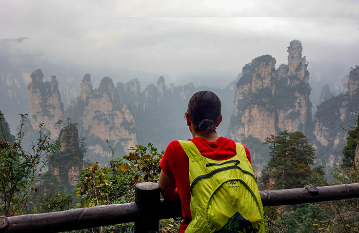 Nic leaning on a fence looking out at the view when visiting zhangjiajie, china