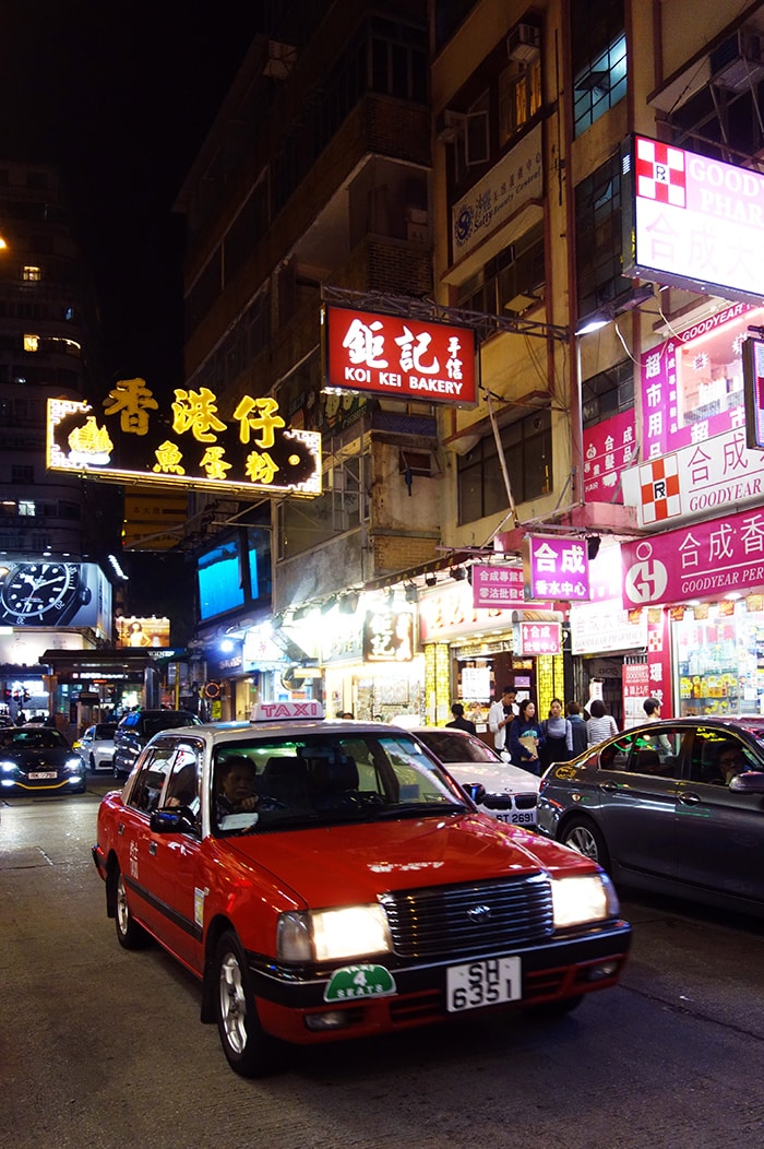 A famous Hong Kong taxi and neon signs in Chinese, Backpacking in Hong Kong for backpackers, Backpackers guide to Hong Kong, Hong Kong on a budget trip 