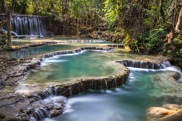 A long exposure shot of Kuang Si waterfall near Luang prabang in Laos with it's clear green water and many levels
