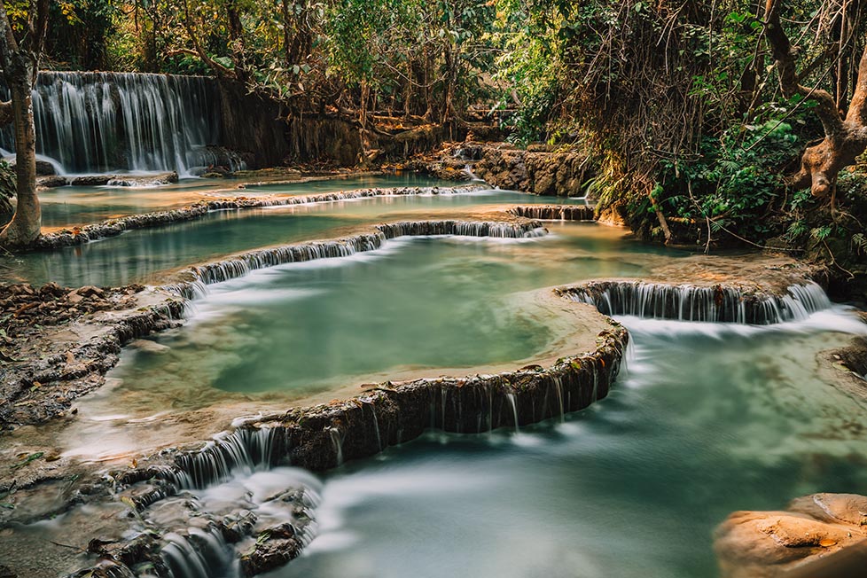 One of the multi levelled pools at Kuang Si waterfall in Luang Prabang, Laos taken with a slow shutter speed long exposure photography