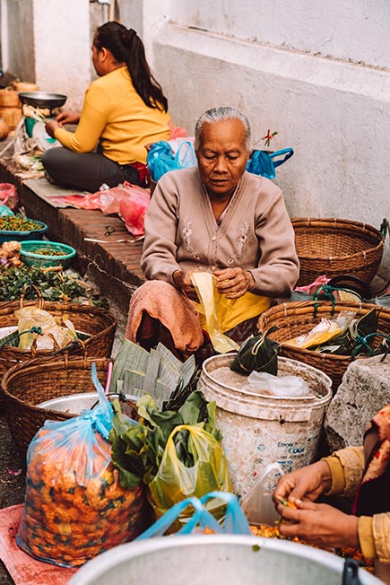 A woman selling items on a street market in Luang Prabang, Laos