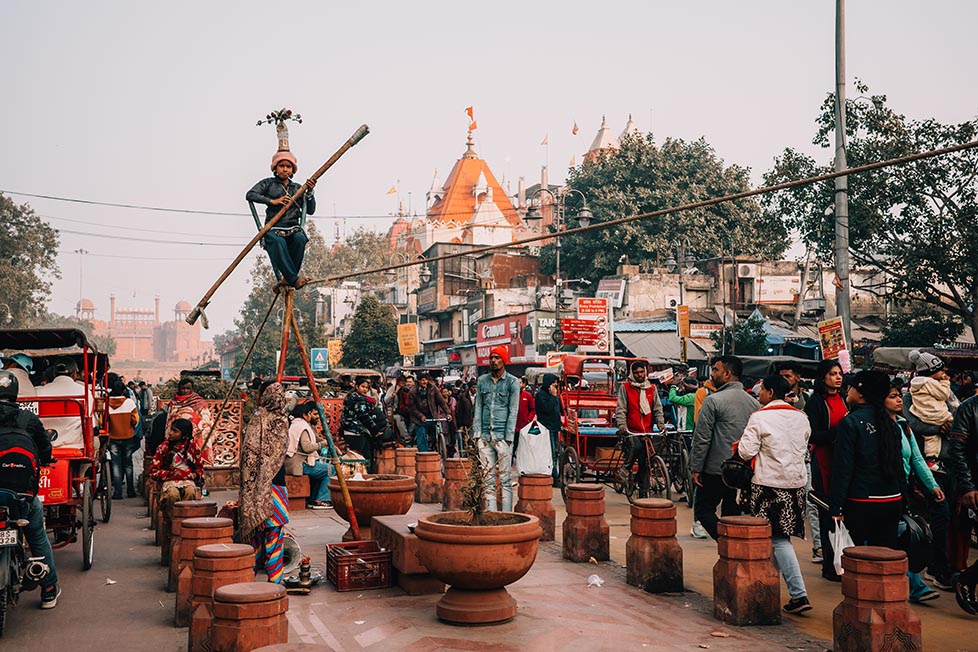 A young girl sitting down after balancing on a rope in Delhi, India to beg for some money.