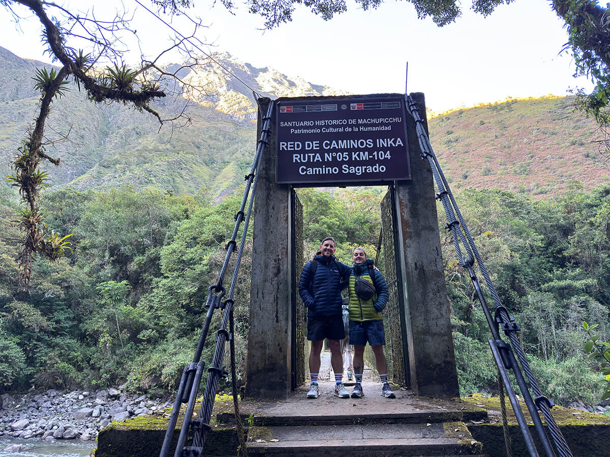 Nic and Shorty standing at the start of the Inca Trail at Kilometer 104 before starting their hike to Machu Picchu