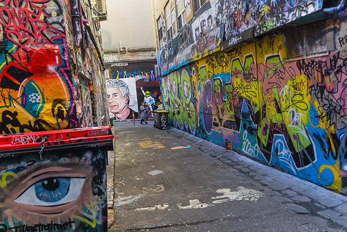 A colourful picture showing the street art and graffiti covering every surface of Hozier Lane in Melbourne, Australia